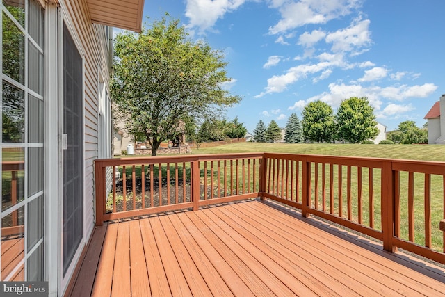 wooden deck featuring a yard