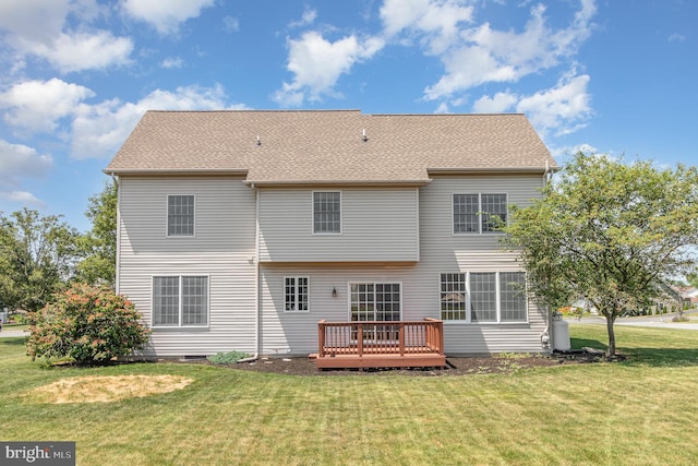 back of house featuring a lawn and a wooden deck