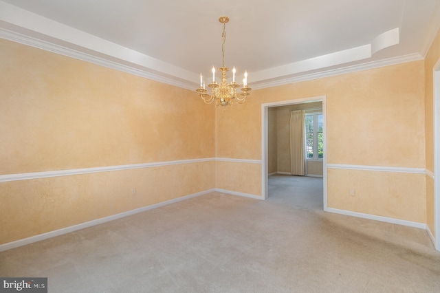 unfurnished room with a tray ceiling, crown molding, carpet, and a chandelier