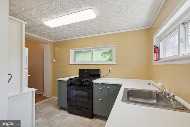 kitchen featuring gray cabinets, black gas stove, white fridge with ice dispenser, and sink