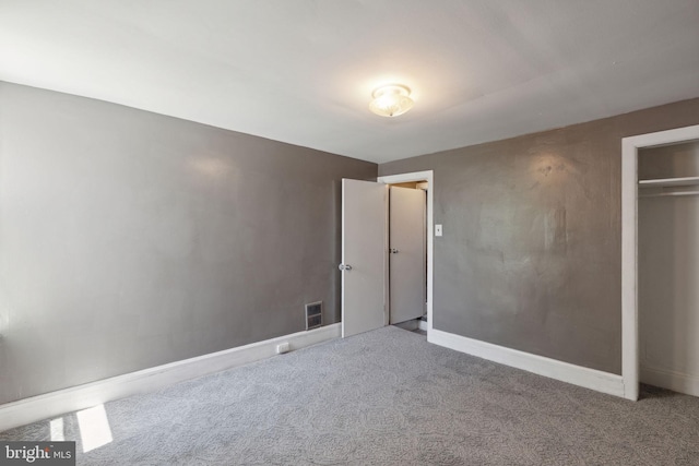 unfurnished bedroom featuring carpet and a closet