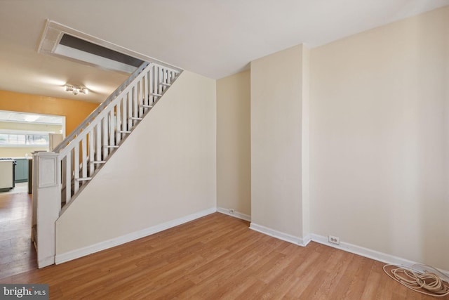 stairs with hardwood / wood-style flooring