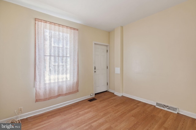 spare room with light hardwood / wood-style floors