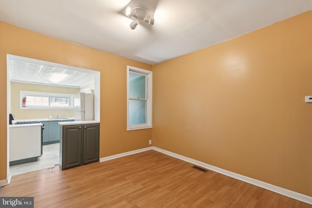 empty room with light hardwood / wood-style flooring