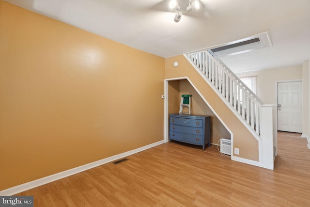 interior space featuring a wall unit AC and hardwood / wood-style flooring