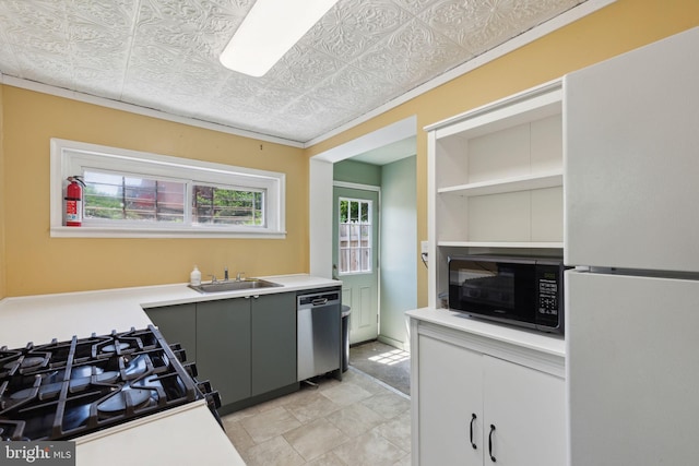 kitchen with range with gas stovetop, white fridge, stainless steel dishwasher, and sink