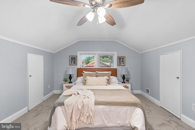 bedroom featuring ceiling fan, light colored carpet, crown molding, and vaulted ceiling