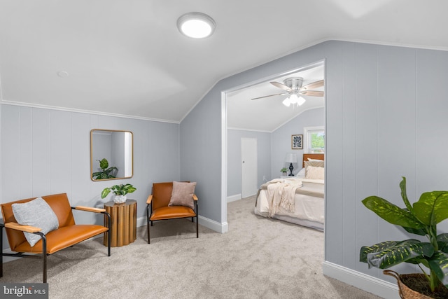 living area featuring ceiling fan, carpet, lofted ceiling, and ornamental molding