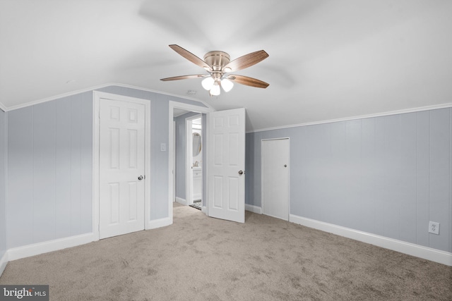 additional living space featuring ceiling fan, light colored carpet, and lofted ceiling