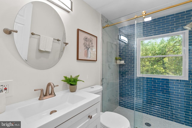 bathroom with a shower with shower door, toilet, and vanity