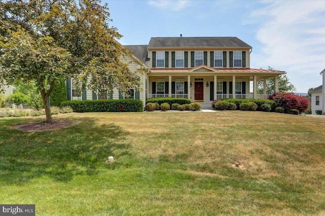 colonial home with covered porch and a front lawn