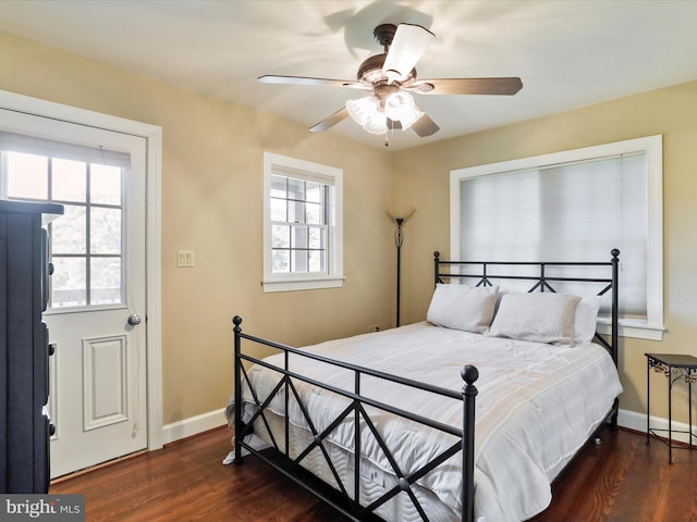 bedroom with ceiling fan and dark wood-type flooring