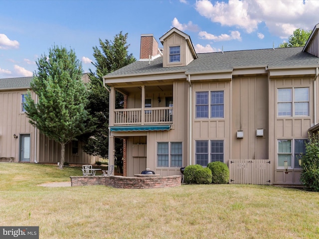 exterior space featuring a balcony and a front yard