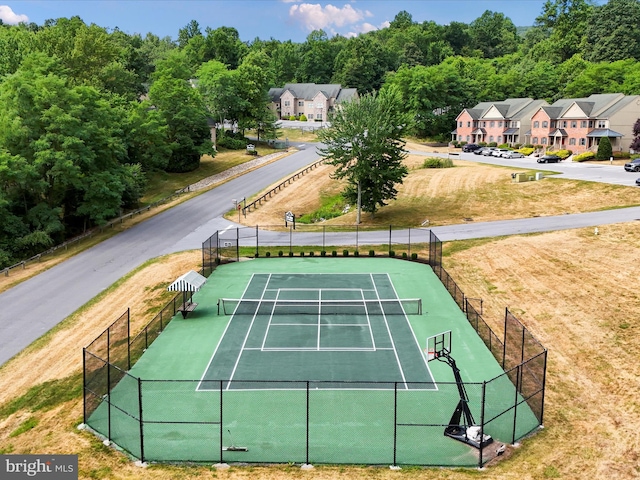 view of sport court featuring a yard