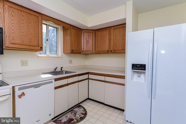 kitchen featuring white appliances and sink