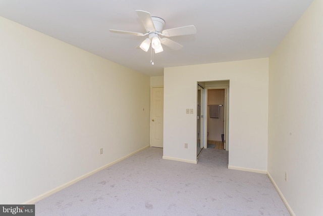 unfurnished bedroom with ceiling fan and light colored carpet