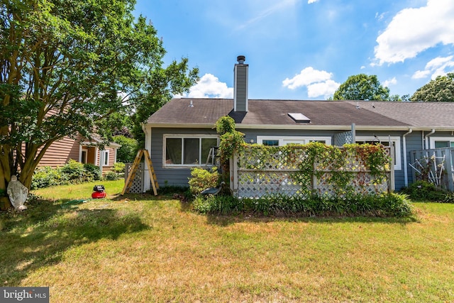 back of property with a lawn