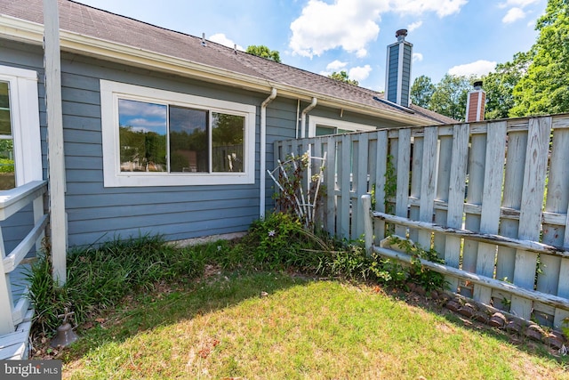 view of property exterior with a yard