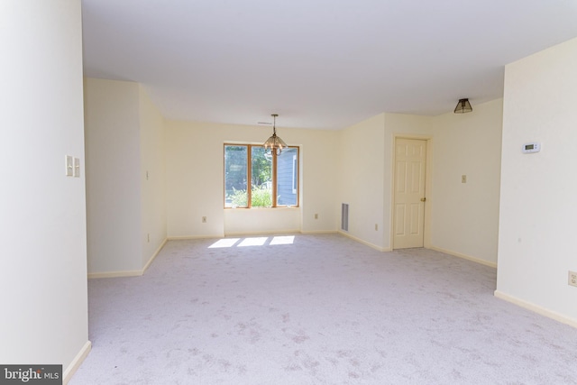 unfurnished room with light carpet