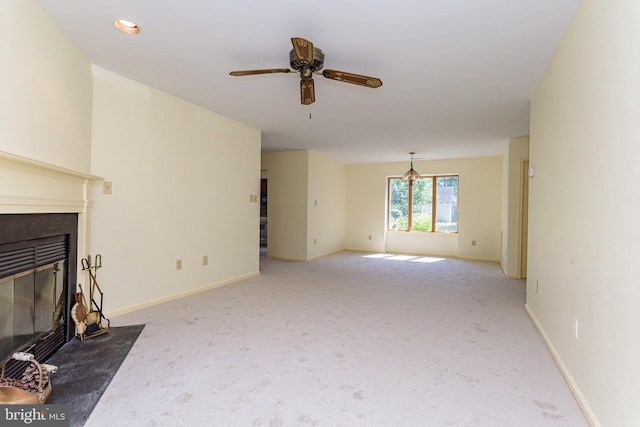 unfurnished living room with ceiling fan and carpet floors