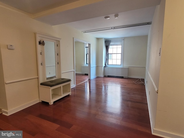 unfurnished room with dark hardwood / wood-style floors and radiator