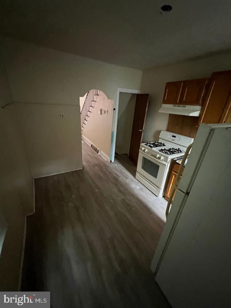 kitchen featuring hardwood / wood-style flooring and white appliances