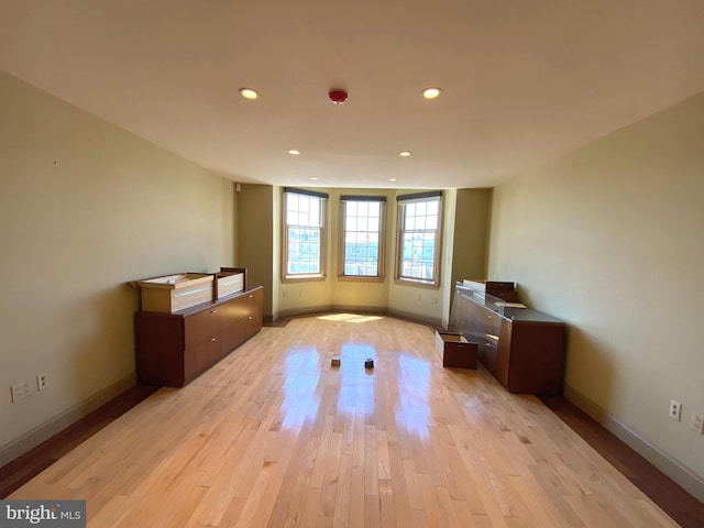 unfurnished room with light wood-type flooring