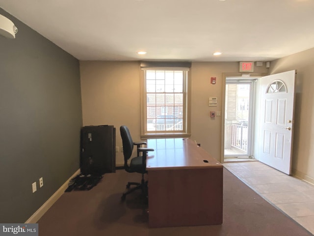 unfurnished office with light tile patterned floors