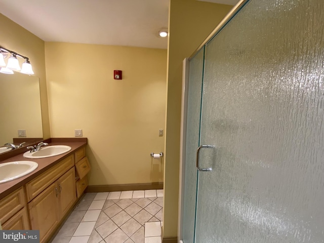 bathroom featuring tile patterned floors, vanity, and an enclosed shower