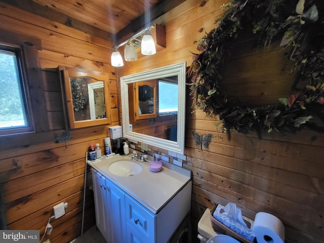 bathroom with wooden walls, vanity, wooden ceiling, and toilet