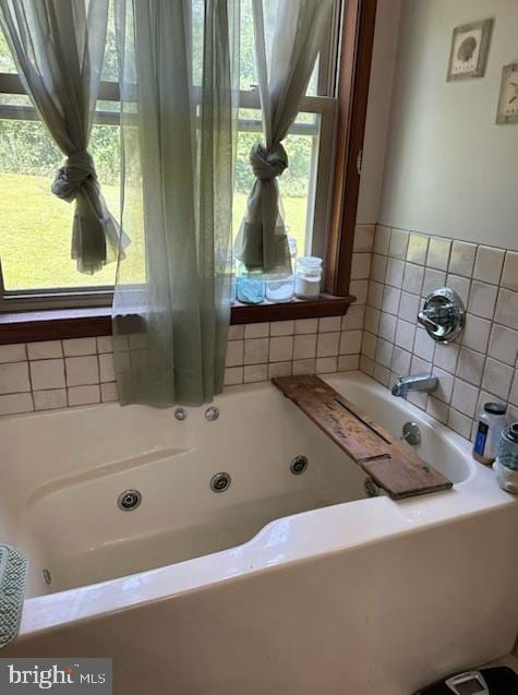 bathroom featuring a bath and plenty of natural light