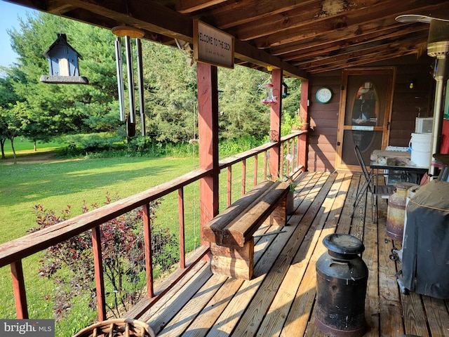 wooden terrace with a yard