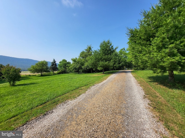 view of street with a mountain view and a rural view