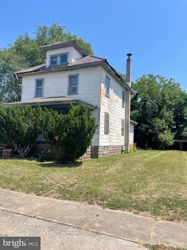 view of home's exterior with a yard