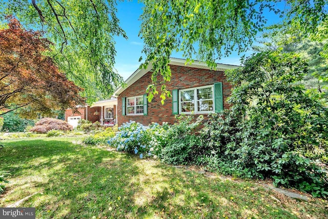 view of side of home with a lawn