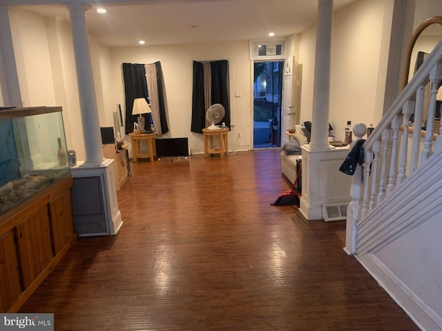 interior space featuring dark hardwood / wood-style flooring and decorative columns