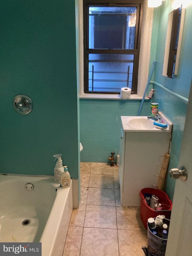 bathroom with tile patterned floors, vanity, and a bath