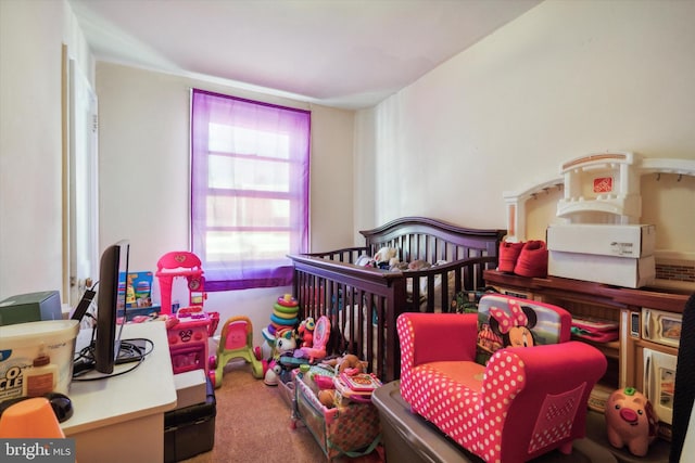 carpeted bedroom with a crib