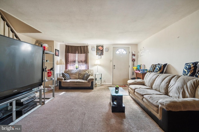 living room featuring carpet floors and a textured ceiling