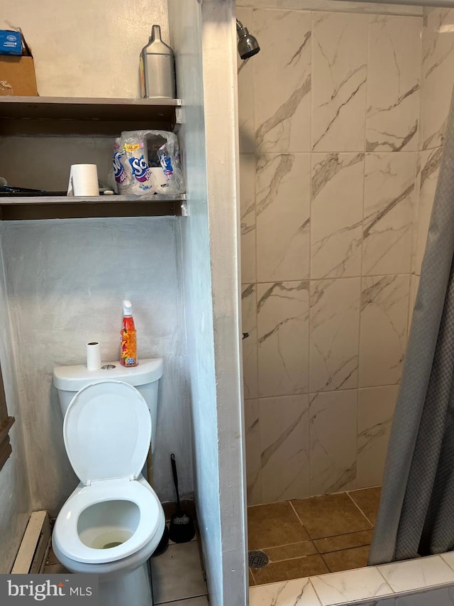 bathroom with curtained shower, toilet, tile patterned flooring, and a baseboard heating unit