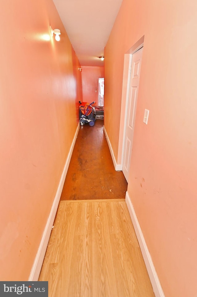 corridor with wood-type flooring