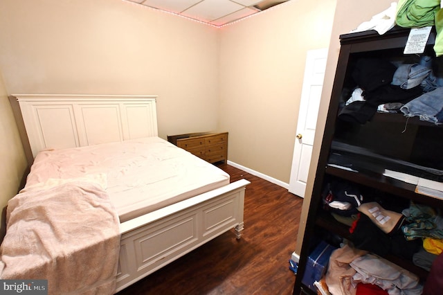 bedroom with dark hardwood / wood-style floors