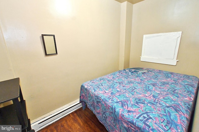 bedroom featuring a baseboard radiator and hardwood / wood-style flooring