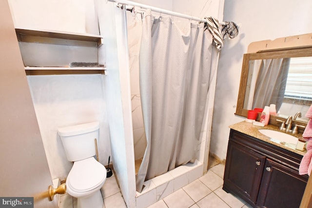 bathroom featuring tile patterned floors, vanity, toilet, and walk in shower