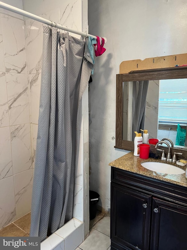 bathroom featuring vanity, tile patterned floors, and walk in shower