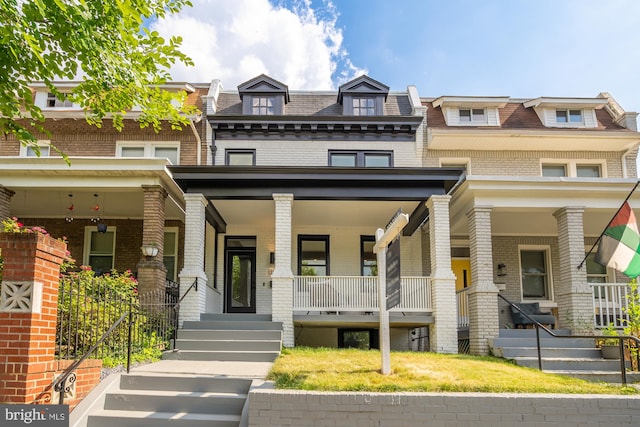 townhome / multi-family property featuring a porch