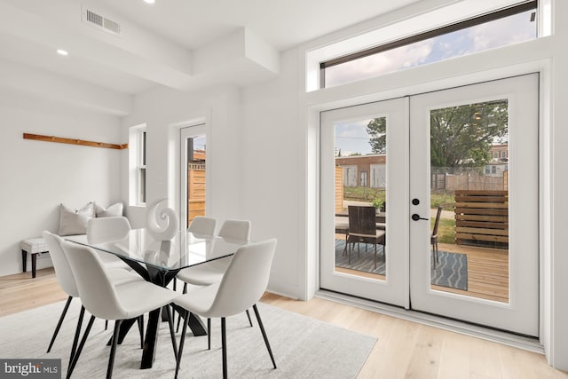 dining space featuring light hardwood / wood-style floors and french doors