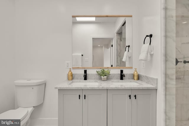 bathroom featuring toilet, vanity, and walk in shower