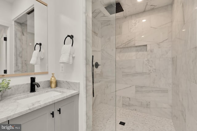 bathroom with vanity and tiled shower