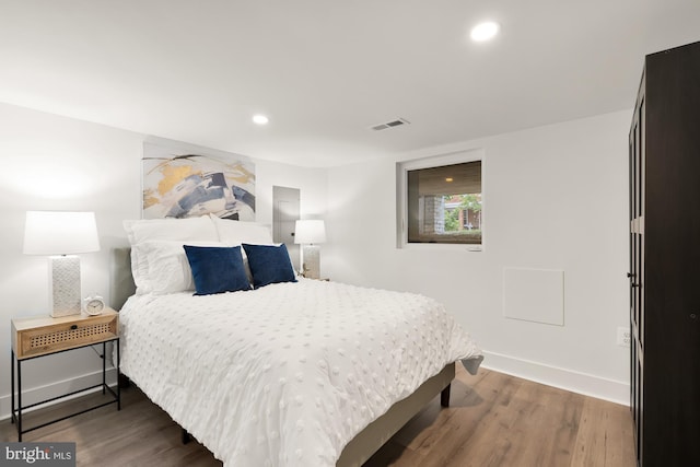 bedroom with dark wood-type flooring